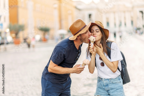 Happy couple eating ice cream in Rome, Italy. Beautiful bright ice cream with different flavors in the hands of a couple. A picture of a happy couple showing ice-cream cones