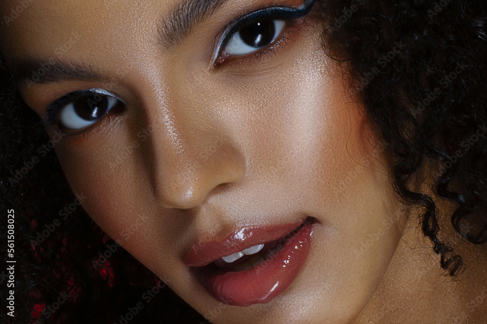 Close-up of beautiful young woman. Arrows, glowing dark skin, wet lip gloss - obrazy, fototapety, plakaty 