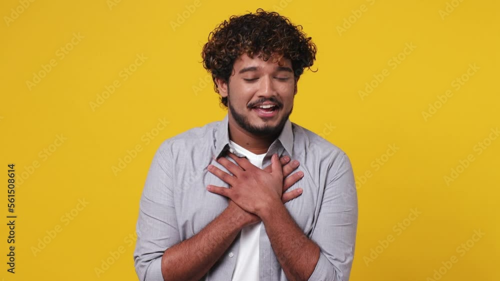 Smiling fun surprised good kind happy oung Indian man 20s wear casual grey shirt ask who for me oh it so sweet put hands on chest isolated on plain yellow background studio. People lifestyle concept Smiling fun surprised good kind happy oung Indian man 20s wear casual grey shirt ask who for me oh it so sweet put hands on chest isolated on plain yellow background studio. People lifestyle concept