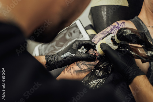 Close Up of Process of Creating Tattoo Art  Artist Draws on the Clients Skin