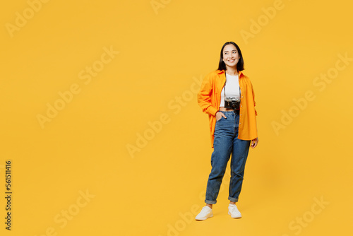 Young happy fun woman wear summer casual clothes look aside on area mock up isolated on plain yellow background. Tourist travel abroad in free spare time rest getaway. Air flight trip journey concept.