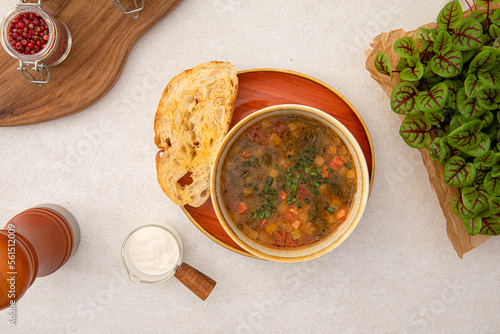 Portion of sorrel soup with grilled veal and toasted bread photo