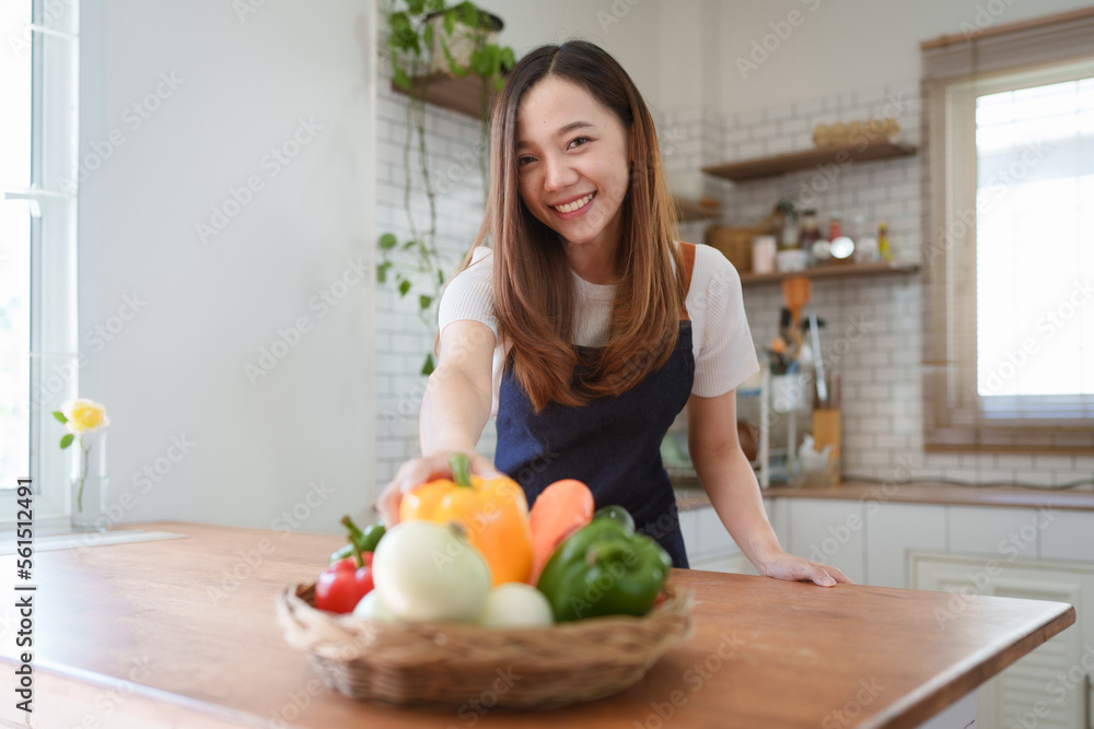 Portrait of beautiful young asian woman making salad at home. cooking food and Lifestyle moment