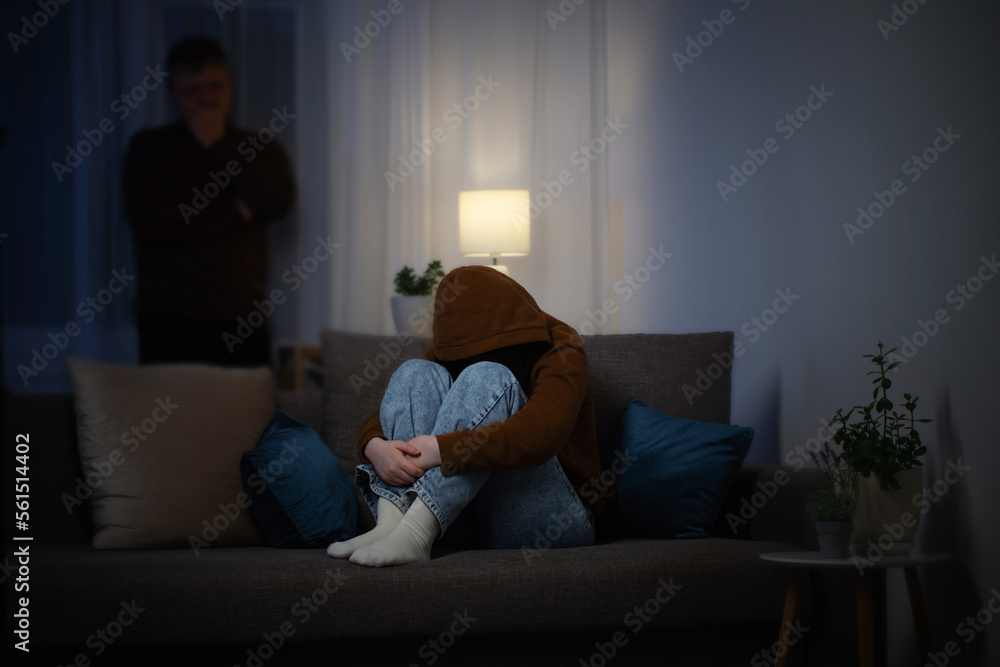 father and daughter teenager in living room in evening, concept of problems in family father and daughter teenager in living room in evening, concept of problems in family
