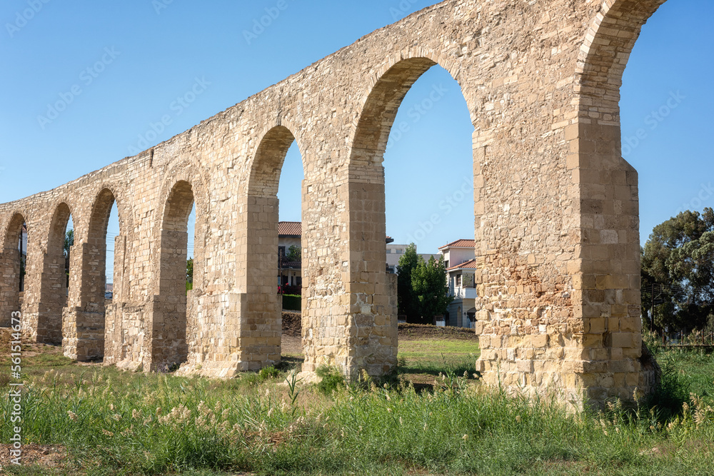 Old Kamares Aqueduct or Bekir Pasha Aqueduct near Larnaca, Cyprus. Scenic view of historical landmark and popular tourist attraction, distinctive arches in Roman style, outdoor travel background
