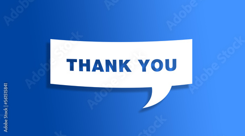 Speech bubble sign with the word thank you in front of a blue colored wall