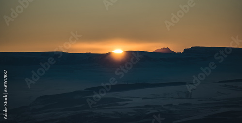 Panorama of the mountain range of the Caucasus Mountains at sunset  view of the mountain peaks in winter in the evening at sunset