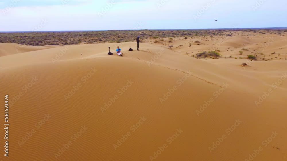 Flight over the dunes in the desert. beautiful top view of the Kyzyl Kum desert in kazakhstan at sunrise. Oriental landscapes of Central Asia, a lifeless arid area without water Flight over the dunes in the desert. beautiful top view of the Kyzyl Kum desert in kazakhstan at sunrise. Oriental landscapes of Central Asia, a lifeless arid area without water