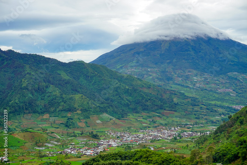 Beautiful natural view. Mountain Sindoro with clouds of Dieng. 
