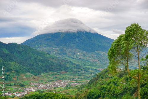 Beautiful natural view. Mountain Sindoro with clouds of Dieng. 