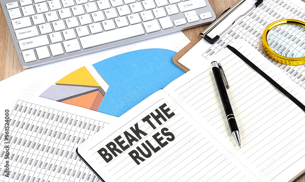 BREAK THE RULES text on notebook with chart and keyboard BREAK THE RULES text on notebook with chart and keyboard