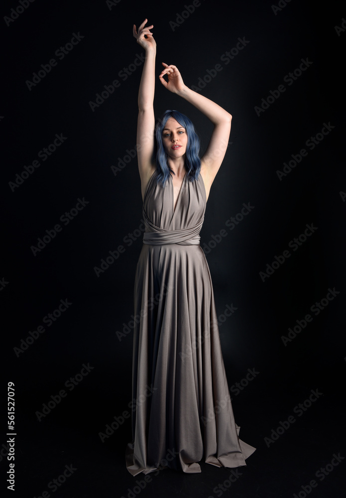 close up portrait of pretty girl with blue hair wig & elegant gown with expressive facial expressions & gestural arm poses. colourful neon gel lighting, isolated on studio background. close up portrait of pretty girl with blue hair wig & elegant gown with expressive facial expressions & gestural arm poses. colourful neon gel lighting, isolated on studio background.