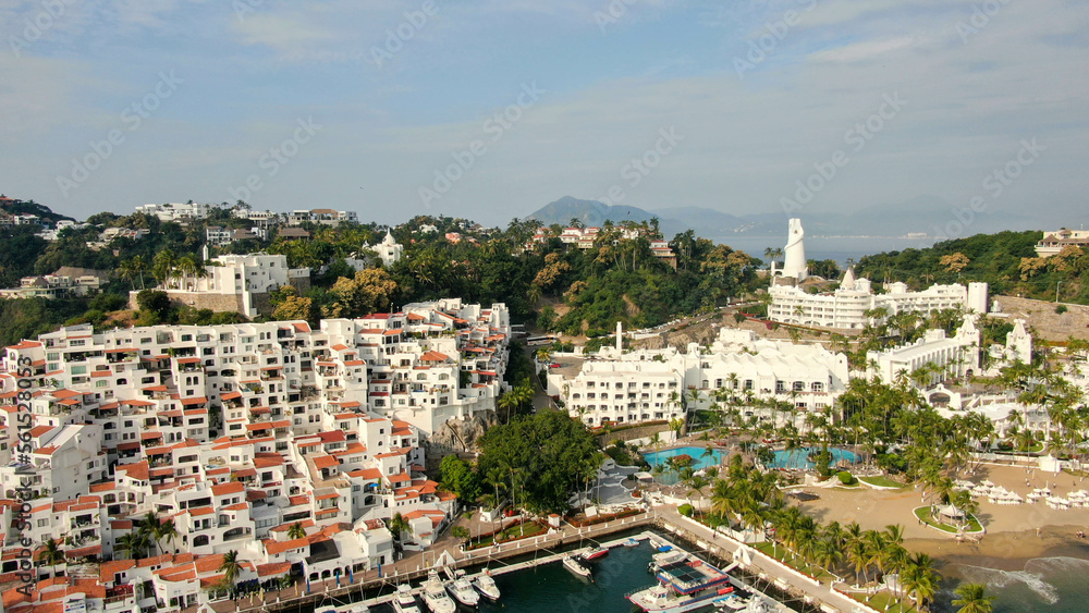 Naklejka premium Manzanillo, Mexico - 11.21.2022 Aerial view of Peninsula de Santiago in city Manzanillo, Mexico. Beautiful luxury hotels and boat and yacht berth