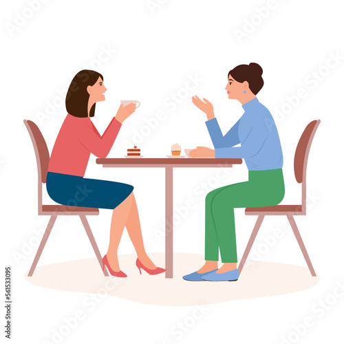 Smiling women sit at the table and chat in a cafe. Female friends drinking tea or coffee together. People enjoying coffee break in public place, having tea in restaurant,conversation, eating. 