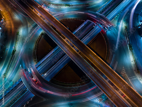  car traffic transportation above circle roundabout road in Asian city. Drone aerial view fly in circle, high angle. Public transport or commuter city life concept, expressway