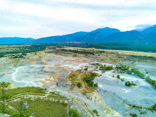 Sand craters in Montenegro and modern equipment and machines for the extraction of sand against the backdrop of mountains