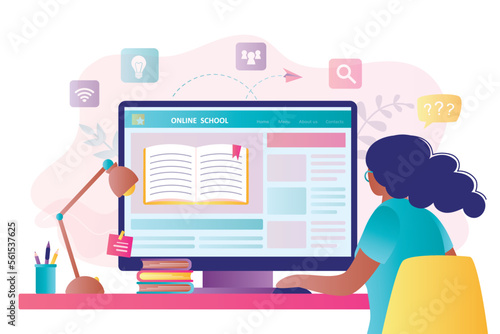 African American girl student studying online. Distance education, home schooling. Internet education technologies. Smart schoolgirl is sitting at workplace and looking at monitor.