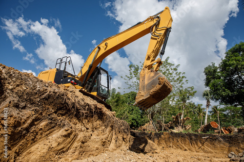 A large construction excavator of yellow color on the construction site in a quarry for quarrying. Industrial image.