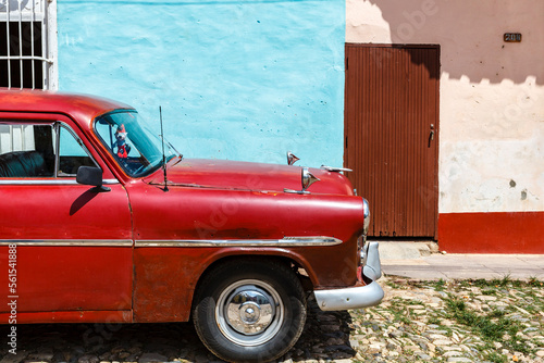 Billede på lærred Red vintage car with smurf in the old center of Trinidad, Cuba, Caribbean