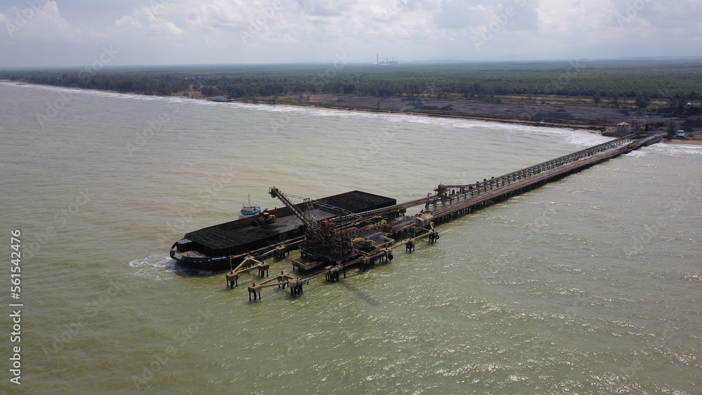 Aerial view of the activity loading coal into barges in a shipyard Aerial view of the activity loading coal into barges in a shipyard