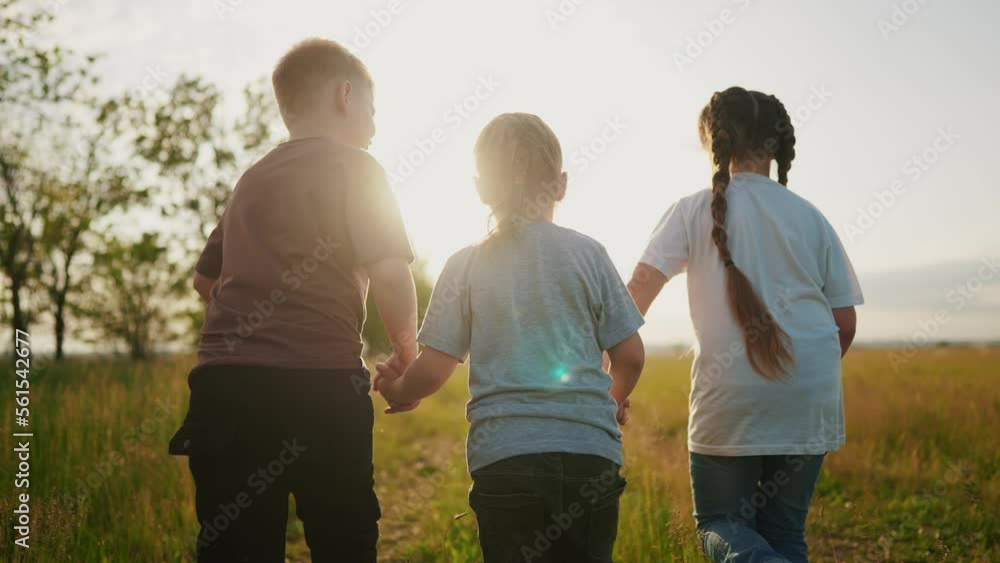 children running in the park holding hands. happy family kindergarten kid dream concept. team of children hold hands run work as a team. children lifestyle kid run in the park children running in the park holding hands. happy family kindergarten kid dream concept. team of children hold hands run work as a team. children lifestyle kid run in the park