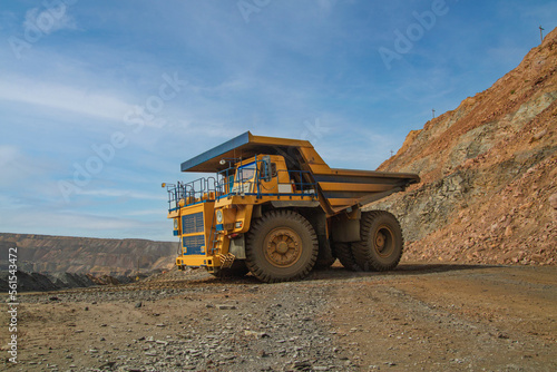 Large dump truck for removal of rock mass from the quarry for open-pit mining of minerals. Initial stage of melalurgy, machinery for the extraction of raw ore.