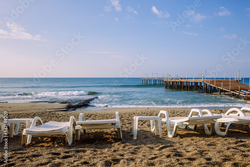Sunbeds in a row on empty beach in Turkey © Ann