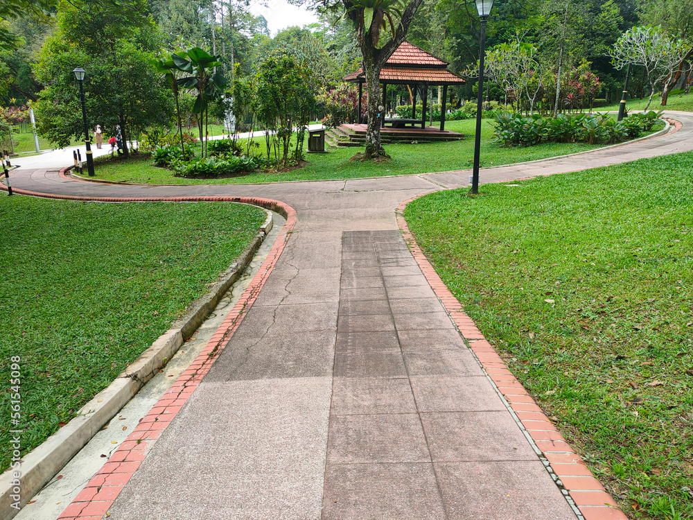 KUALA LUMPUR, MALAYSIA -JULY 6, 2022: Pedestrian path in a public park. Providing comfort for the public to stroll or have fun in the public park. Comfortable and spacious.