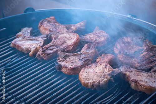 pork steaks being cooked on the grill