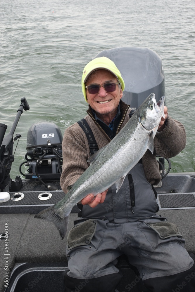 A smiling angler with a salmon A smiling angler with a salmon