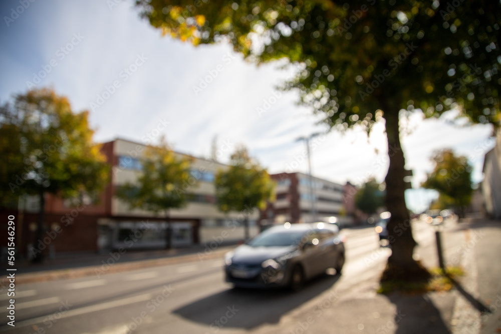 Fototapeta premium Blurry shot of a traffic during day in town scenery