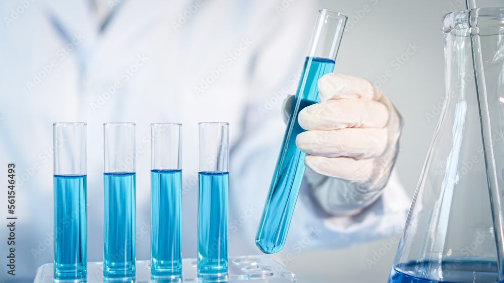Scientist experimental in laboratory with test tube and beaker for medical research Scientist experimental in laboratory with test tube and beaker for medical research