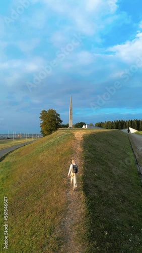 Vertical video: person walking on the road near to beach on sunset
