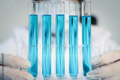 Asian Scientist experimental in laboratory with test tube and beaker for medical research