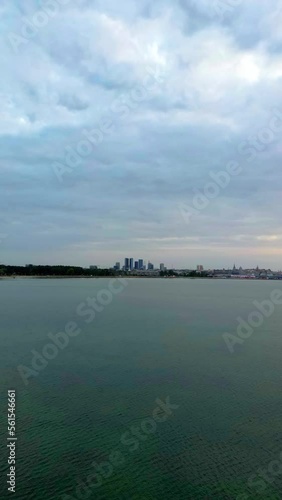 Vertical video: hyperlapse with city, sea and sunset views