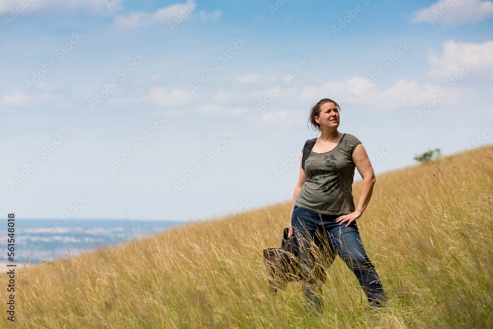 woman standing at hillside in a meadow
woman standing at hillside in a meadow
