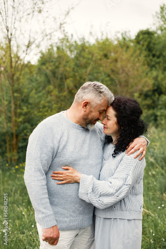 Senior couple standing in a park and looking on each other