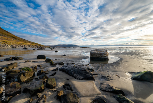 Rising sun at a sandy beach with beautiful rocks in the Westfjords in the morning, Iceland, stock photo, Europe photo