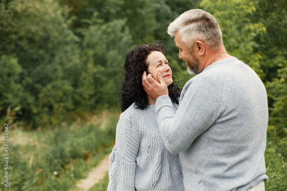 Obraz premium Senior couple standing in a park and looking on each other