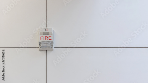 A fire alarm with built in strobe light to alert in case of fire. A sound and strobe fire alarm is mounted to an interior wall as part of the fire alarm system photo