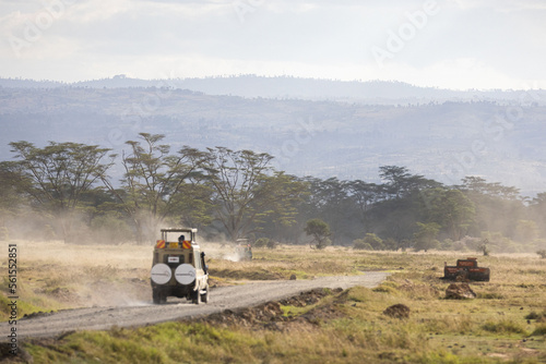 Safari vehicles crossing a path in Lake Nakura