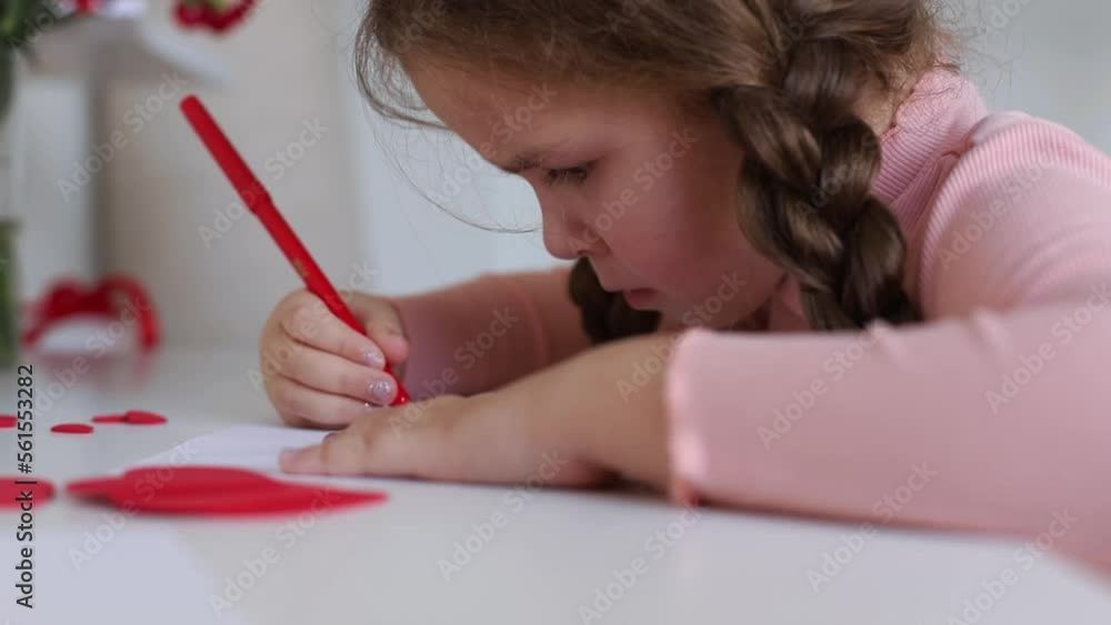 Girl Drawing On Paper At Table, Little Girl drawing with Colored Markers on Paper at Home. Close Up. Girl Drawing On Paper At Table, Little Girl drawing with Colored Markers on Paper at Home. Close Up.