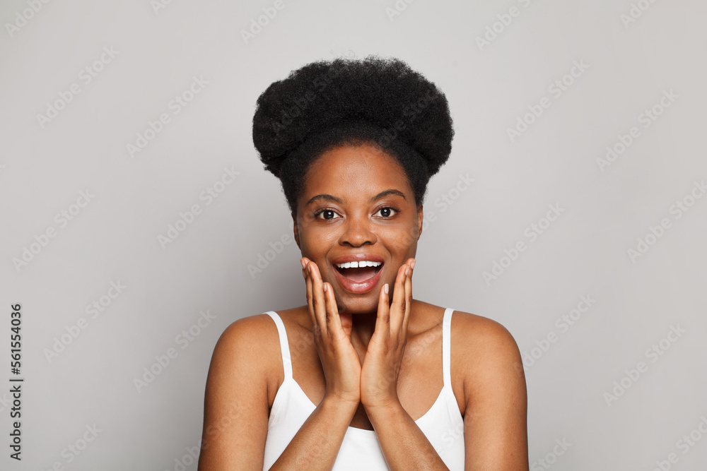 Excited young woman with fresh clean skin smiling on white. Beauty, facial treatment, skin care and cosmetology concept