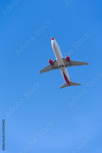 Travel, aviation passenger airplane flying in blue sky, bottom view