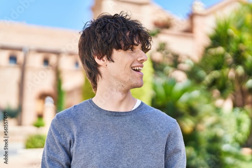 Young hispanic man smiling confident standing at park