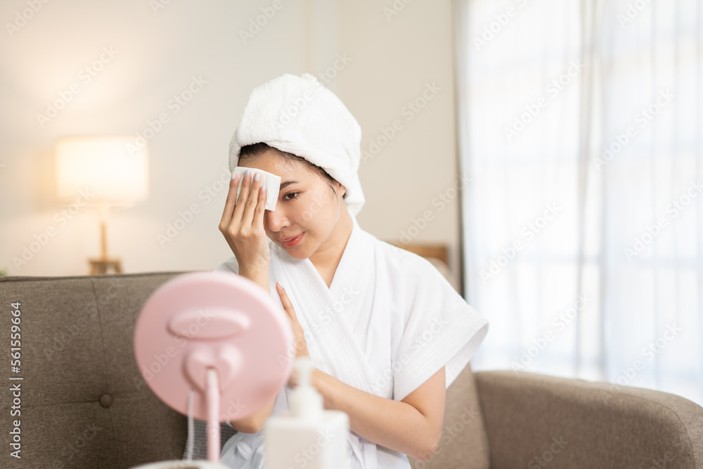 Beautiful brunette woman removing makeup from her face. Beautiful brunette woman removing makeup from her face.