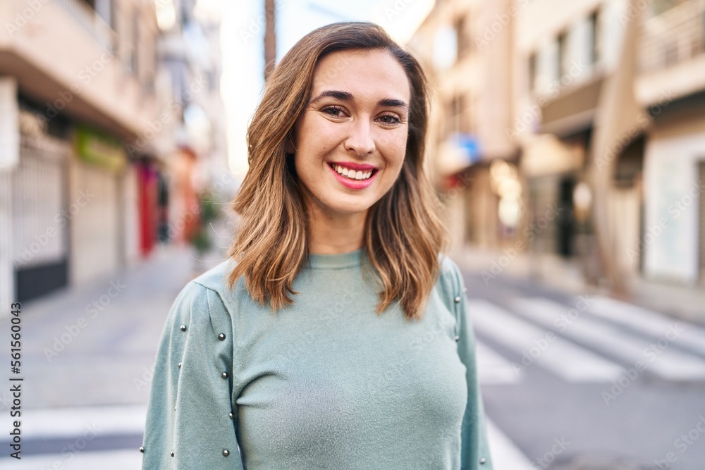 Young woman smiling confident standing at street