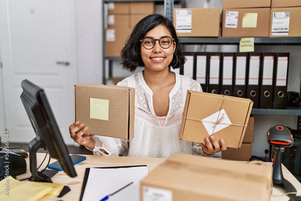 Young hispanic woman working at small business ecommerce smiling with a happy and cool smile on face. showing teeth. Young hispanic woman working at small business ecommerce smiling with a happy and cool smile on face. showing teeth.