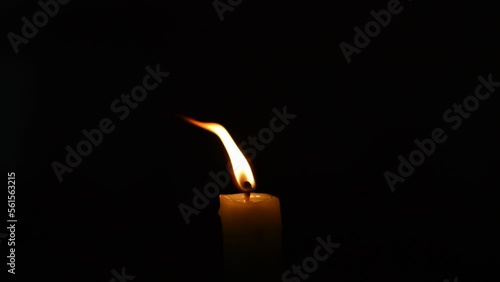 close-up red flame of a candle. candle burning in the dark background. candle burning in a night dark background. red fire flame of a candle