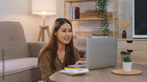 Working at home concept, Female freelance sitting on floor to working and shopping online on laptop